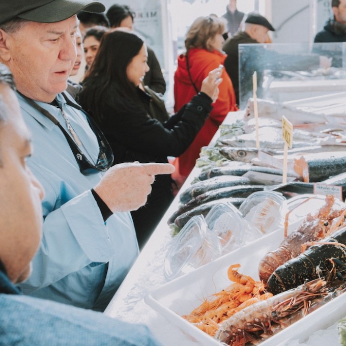 man during a tour in a local market