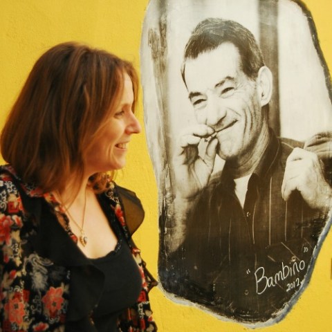 Camilla Watson in front of a painting