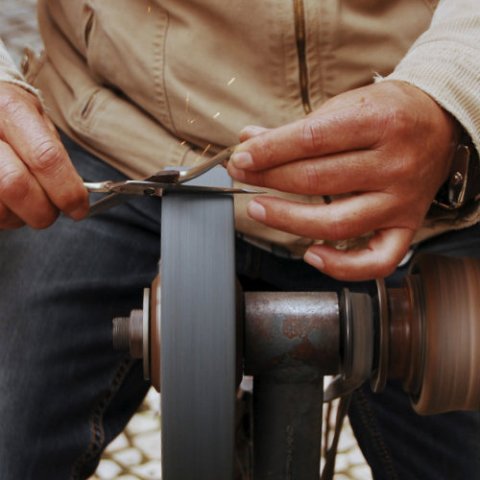 Artisan fixing old scissors