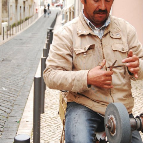 Man fixing old scissors