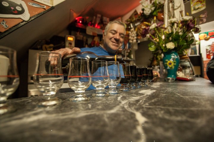 Lisbon old pub owner serving Ginjinha