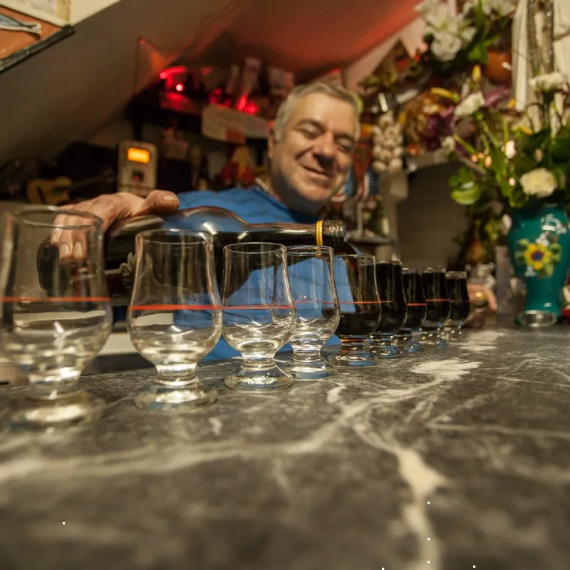 Lisbon old pub owner serving Ginjinha