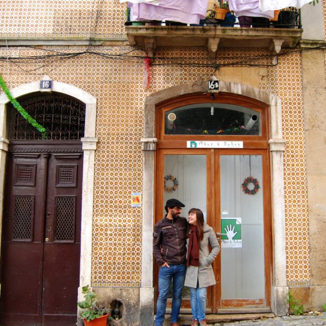 couple posing in front of a house