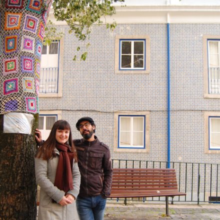 Couple posing near a colorful tree