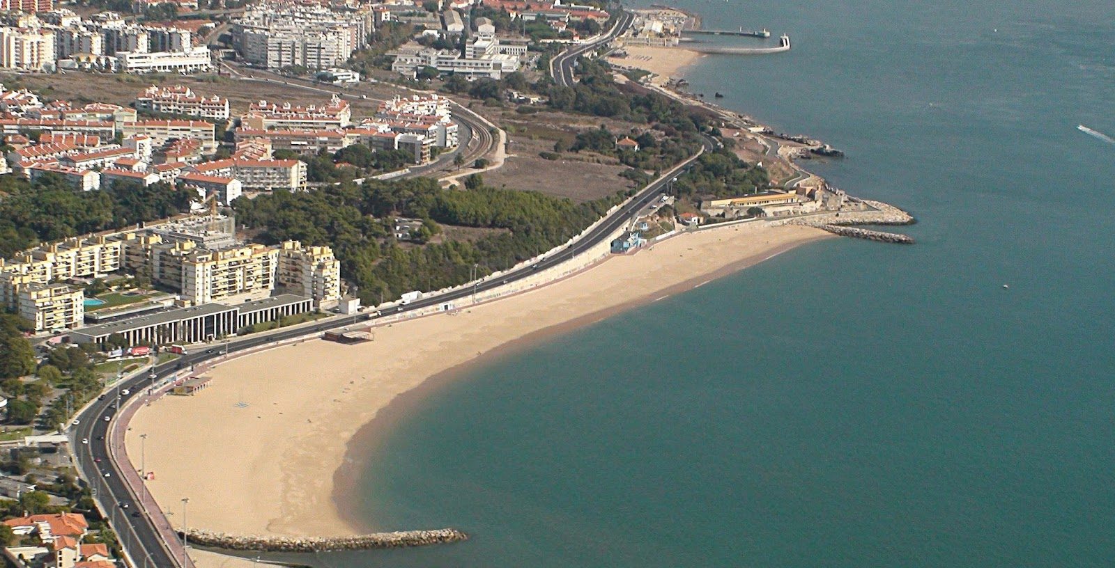 a large body of water with a city in the background