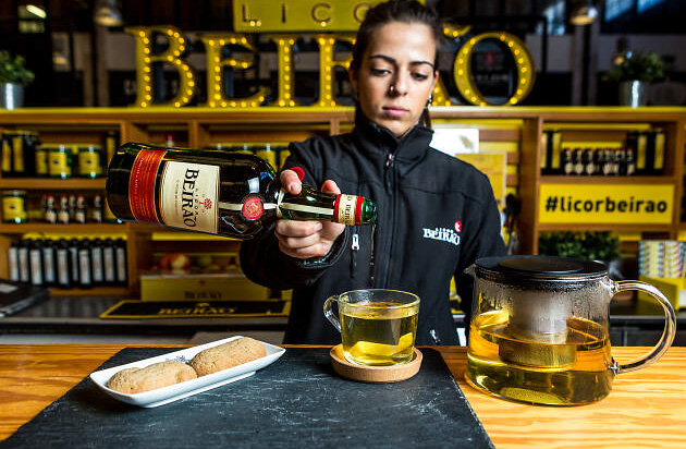 a person sitting at a table with a cup of coffee