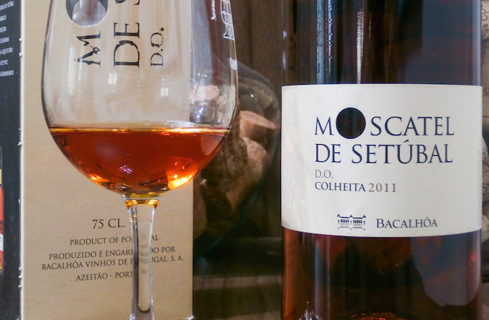 a close up of a bottle and a glass of wine