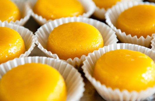 a bowl of oranges on a table