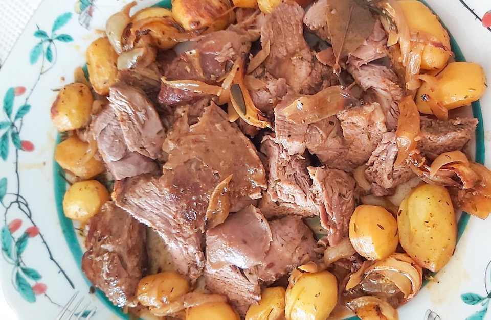a plate of food with meat and vegetables