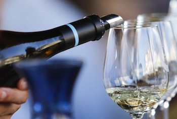a hand holding a glass of wine