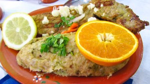 a plate of food with a slice of orange