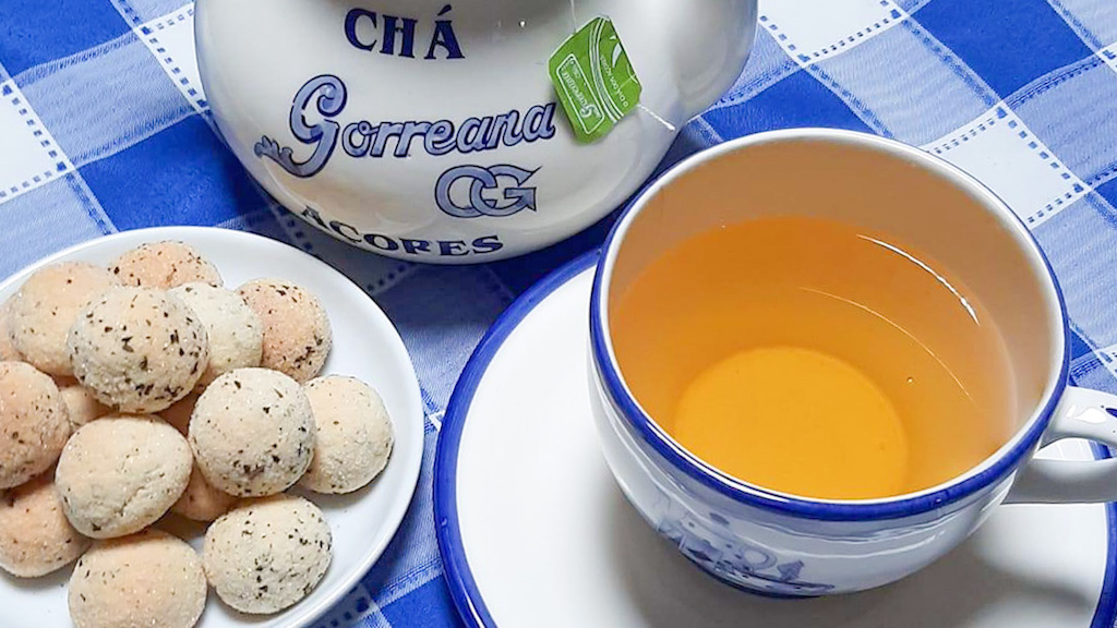 a bowl of food on a plate next to a cup of coffee