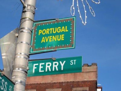 a green street sign hanging from a pole
