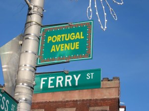 a green street sign hanging from a pole