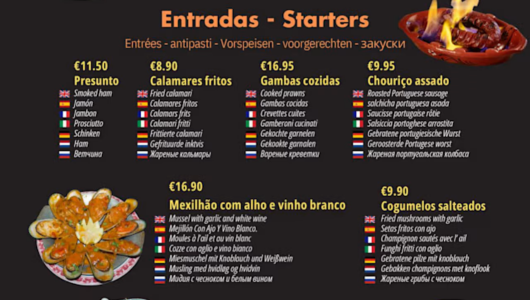 Menu of starters with translation in multiple languages and euro prices, includes dishes like smoked ham and fried calamari.