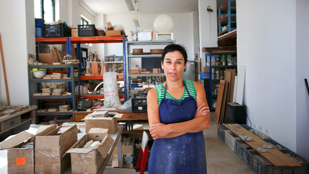 a person sitting at a table looking at a book shelf