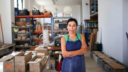 a person sitting at a table looking at a book shelf