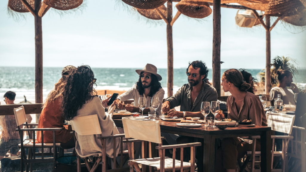 a group of people sitting at a table in a restaurant