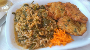 a plate of food with rice meat and vegetables