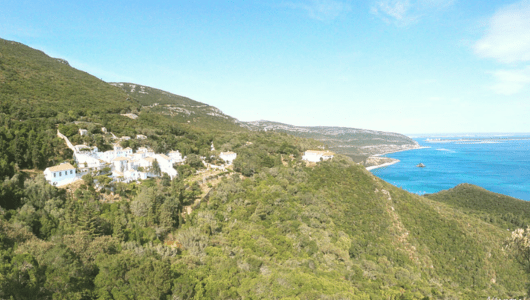 a body of water with a mountain in the background