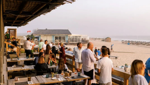 00.Comporta travel guide for food lovers_feat photo a group of people standing around a table
