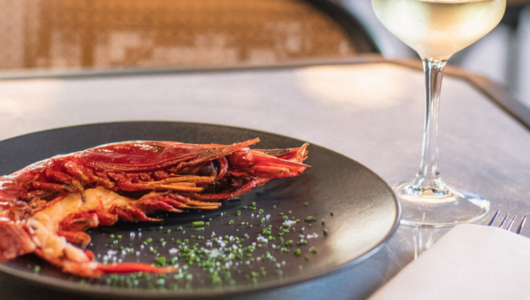 a plate of food and a glass of wine