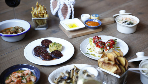 00.Amadora travel guide for food lovers_feat photo several plates of food on a table