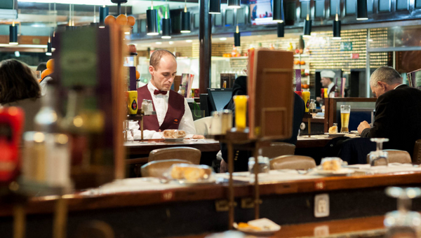 a group of people sitting at a table in a restaurant