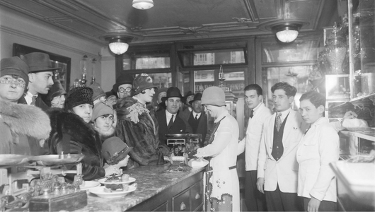 a group of people standing in a coffee shop