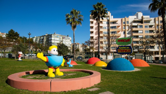 a large lawn with a playground in front of a building