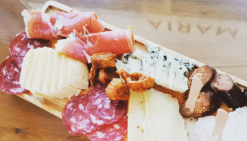 cheeses and sausages on a plate
