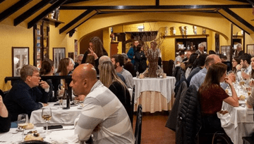 a group of people sitting at a table in a restaurant