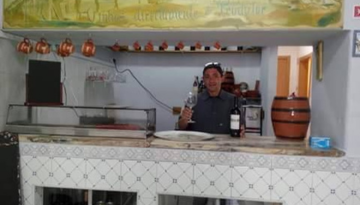  person offering a toast behind a table