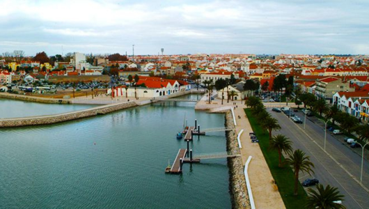 a large body of water with a city in the background