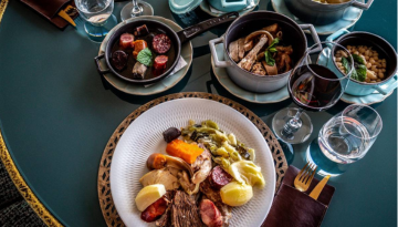 a bowl of food on a plate on a table