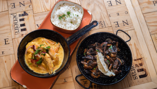 00.Seixal travel guide for food lovers a bowl of food sitting on top of a wooden table