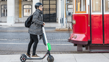 a person riding a bike on a city street