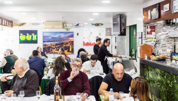 a group of people sitting at a table in a restaurant