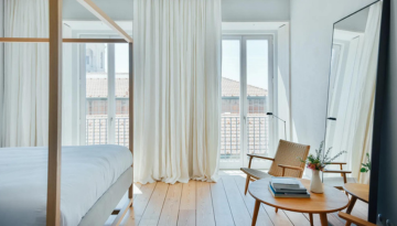a living room filled with furniture and a large window