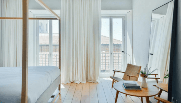a living room filled with furniture and a large window
