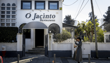 a person walking down a street in front of a building