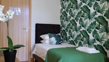 a room filled with furniture and vase of flowers on a table