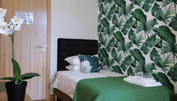 a room filled with furniture and vase of flowers on a table