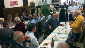 a group of people sitting at a table in a restaurant