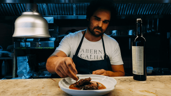 00.Chefs in Lisbon_s culinary scene_feta photo a man sitting at a table with a plate of food