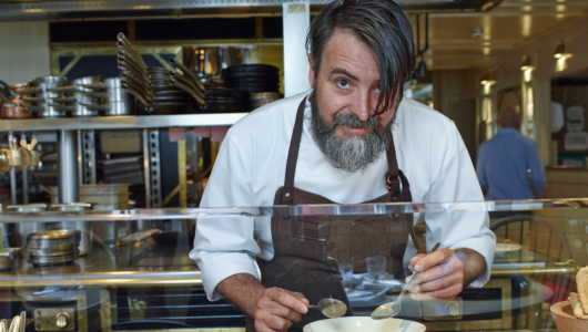 a man preparing food in a restaurant