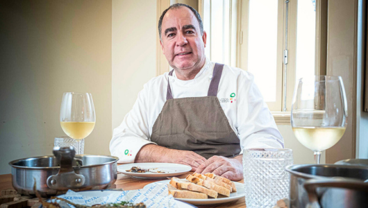 a man sitting at a table with a plate of food