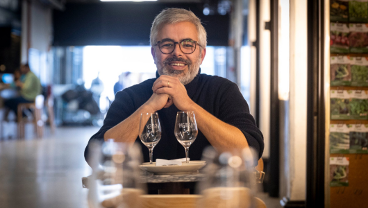 a man standing in front of a table