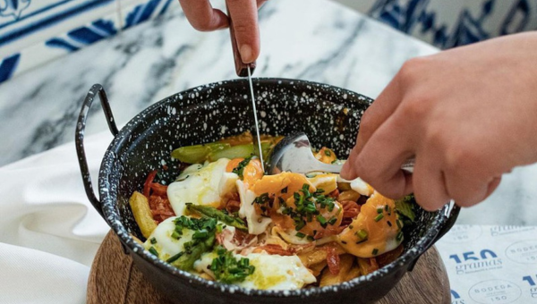 00.Vila Franca de Xira travel guide for food lovers_feat photo a person holding a bowl of food