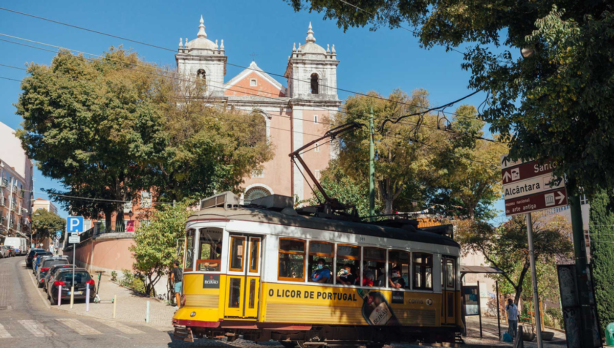 a passenger bus that is driving down the street in front of a building